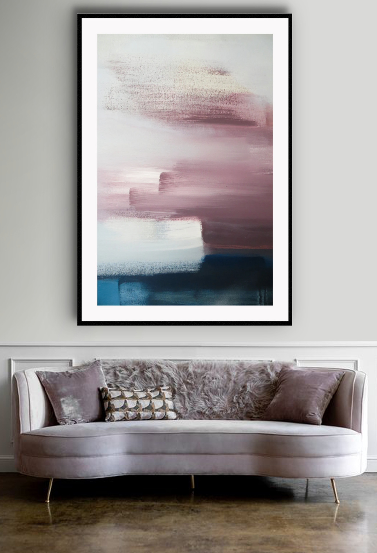 An abstract wall art with white, pink, navy, grey acrylic brushes. On a grey wall above a luxury sofa