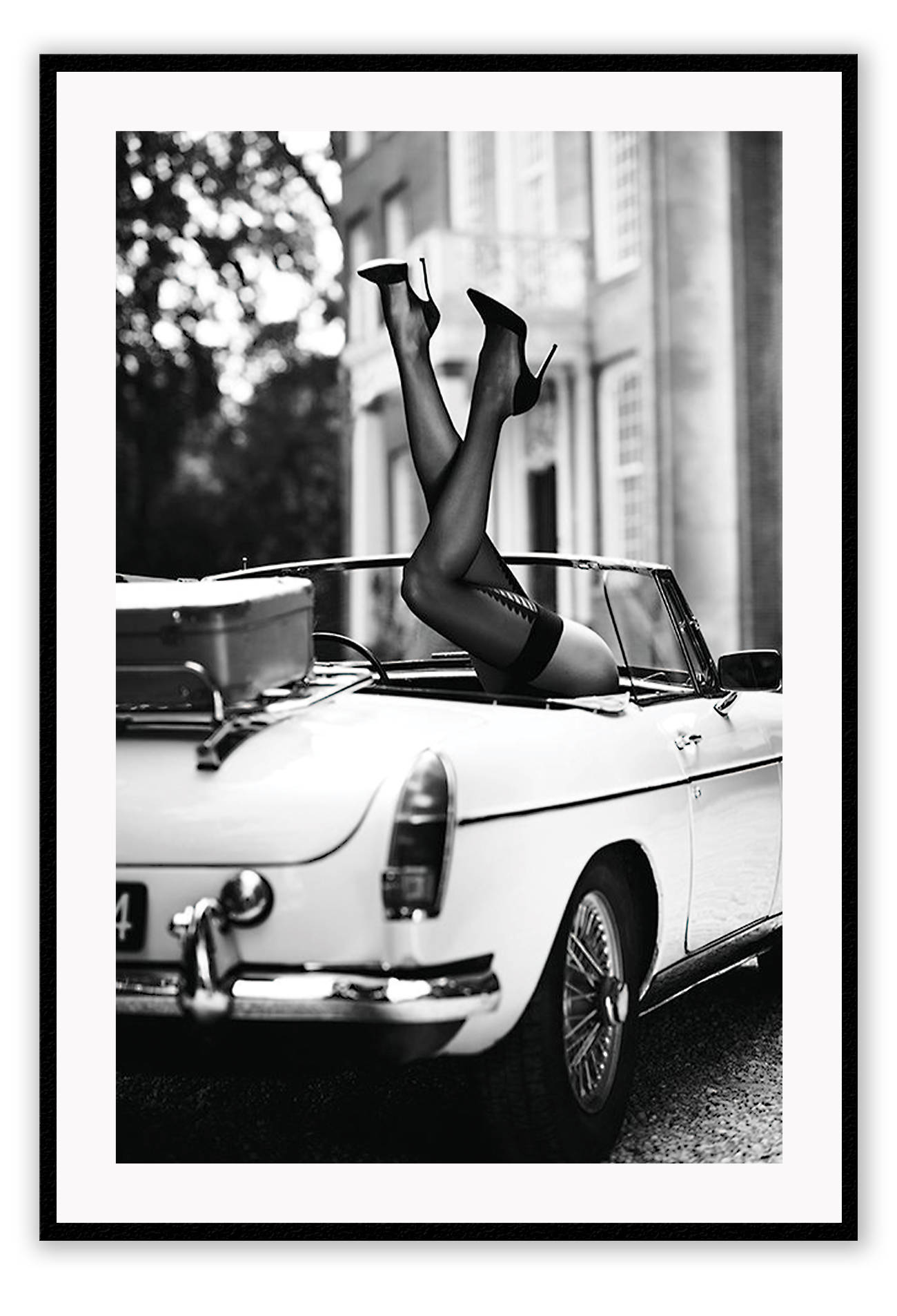 Fashion photography with womans legs coming out of a vintage car black and white lingerie sexy  