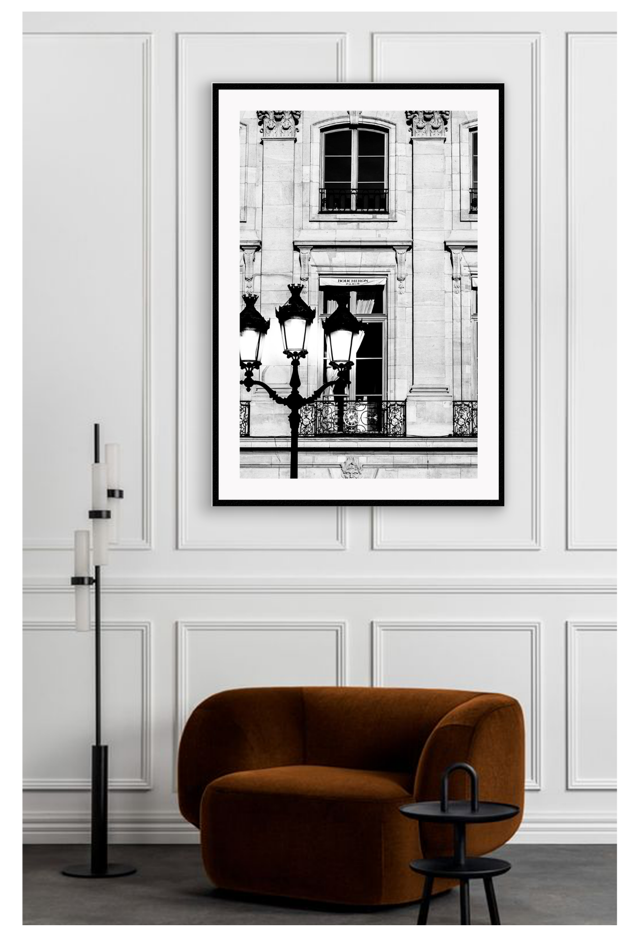 A black and white fashion photography print in Paris with street lamp and architechture. Place on wall above brown lounge chair
