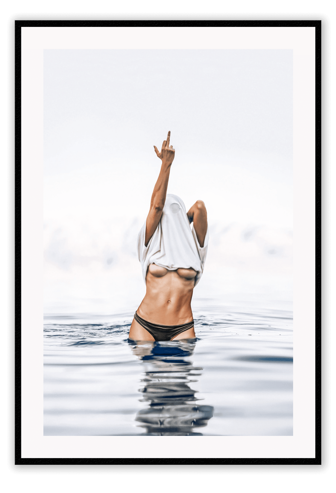 Person in black bikini standing in water with a white towel over their head, against a light gray sky.