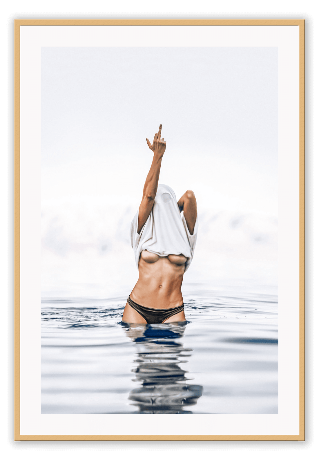 Person in a swimsuit with a white towel over their head, standing in water.