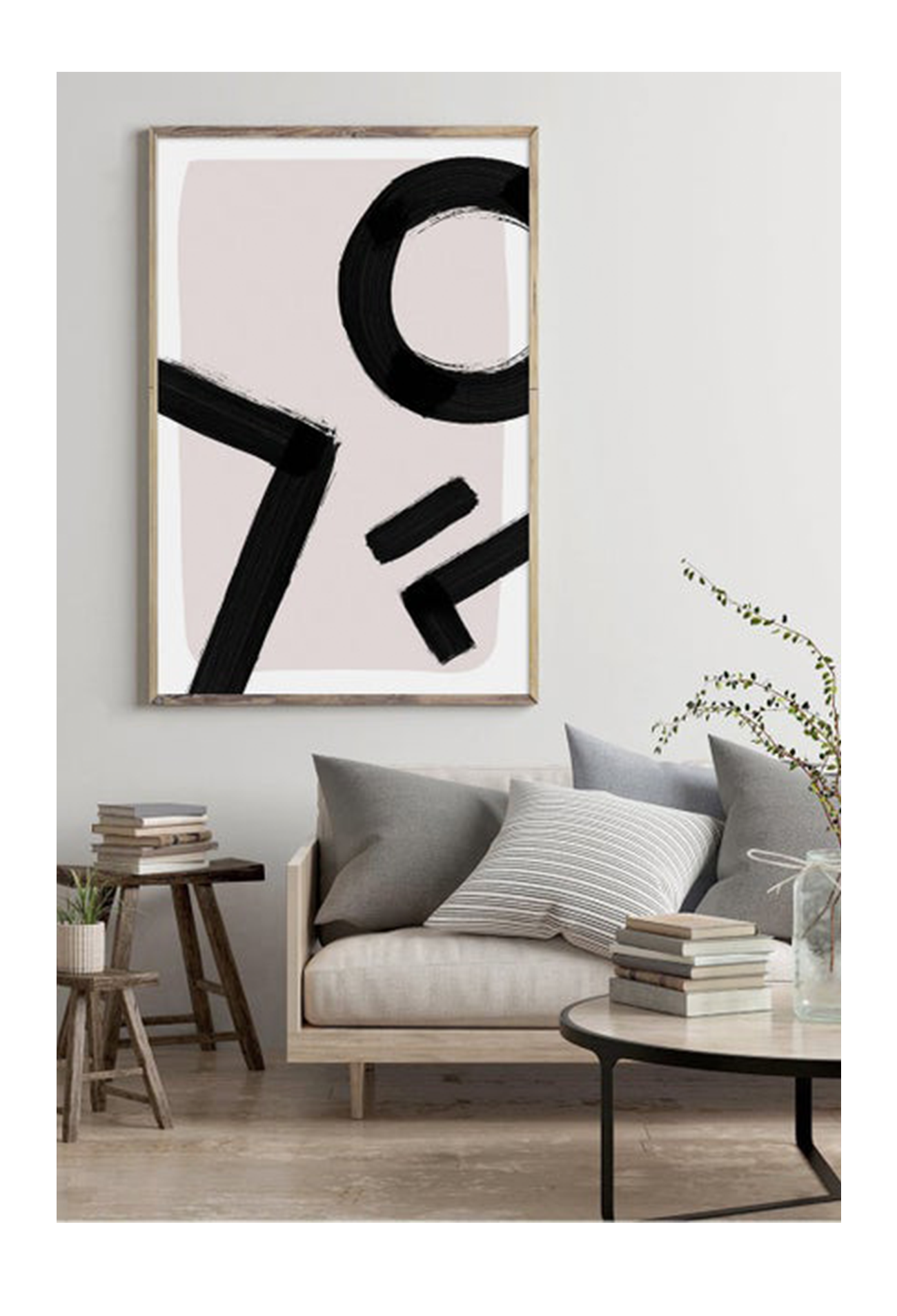 An abstract wall art with black ink brush lines on pink and white background.