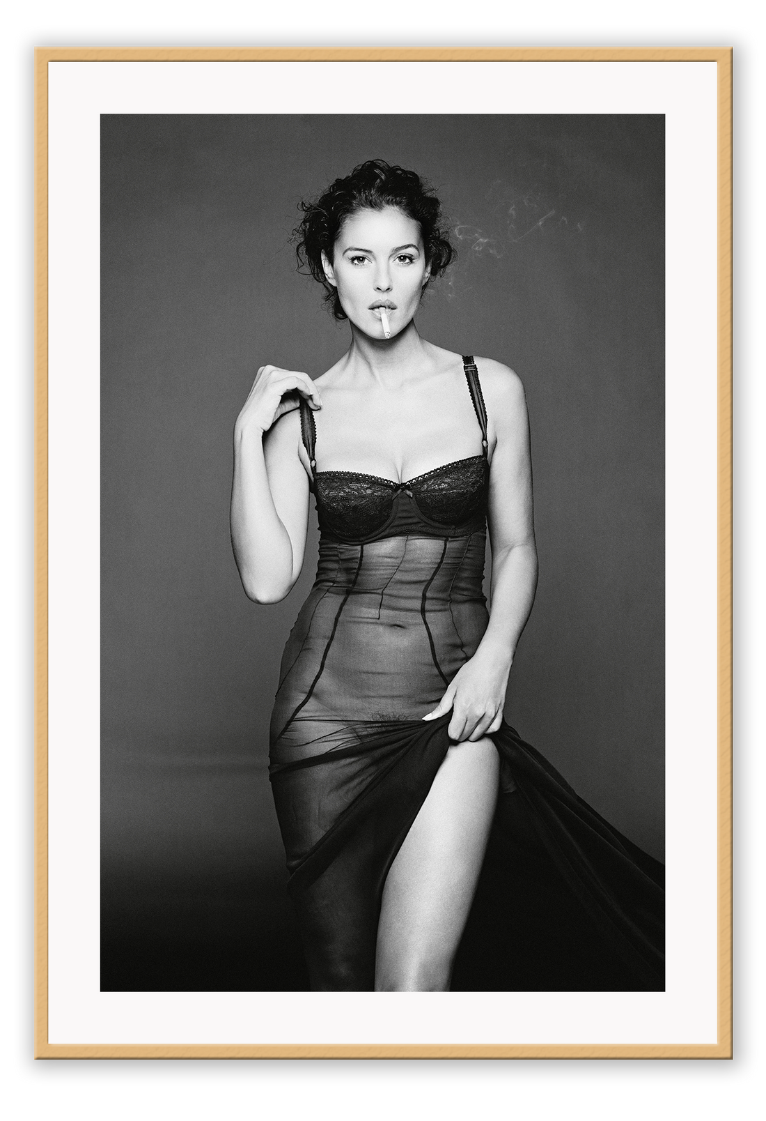 This image features a striking black and white photograph of Monica Bellucci, captured in a portrait orientation. Displayed in a high-quality, custom-made matte wood frame, the print is mounted on perspex glass that enhances its clarity and finish.