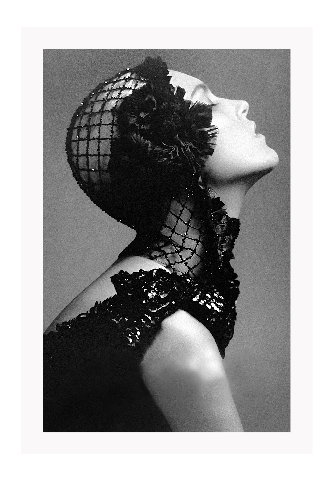 A black and white, vintage fashion wall art with Coco chanel woman wearing black lace flower. 
