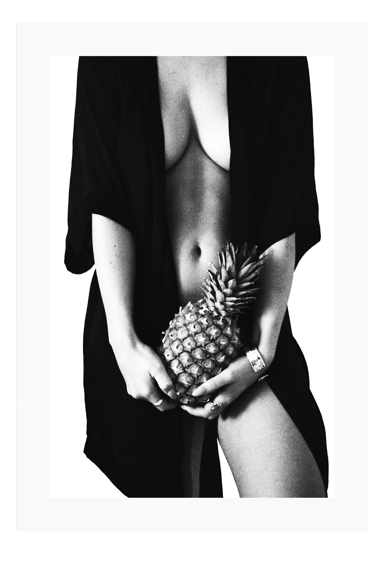 Fashion photography print with nude sexy woman wearing robe holding pinapple in black and white on white background 