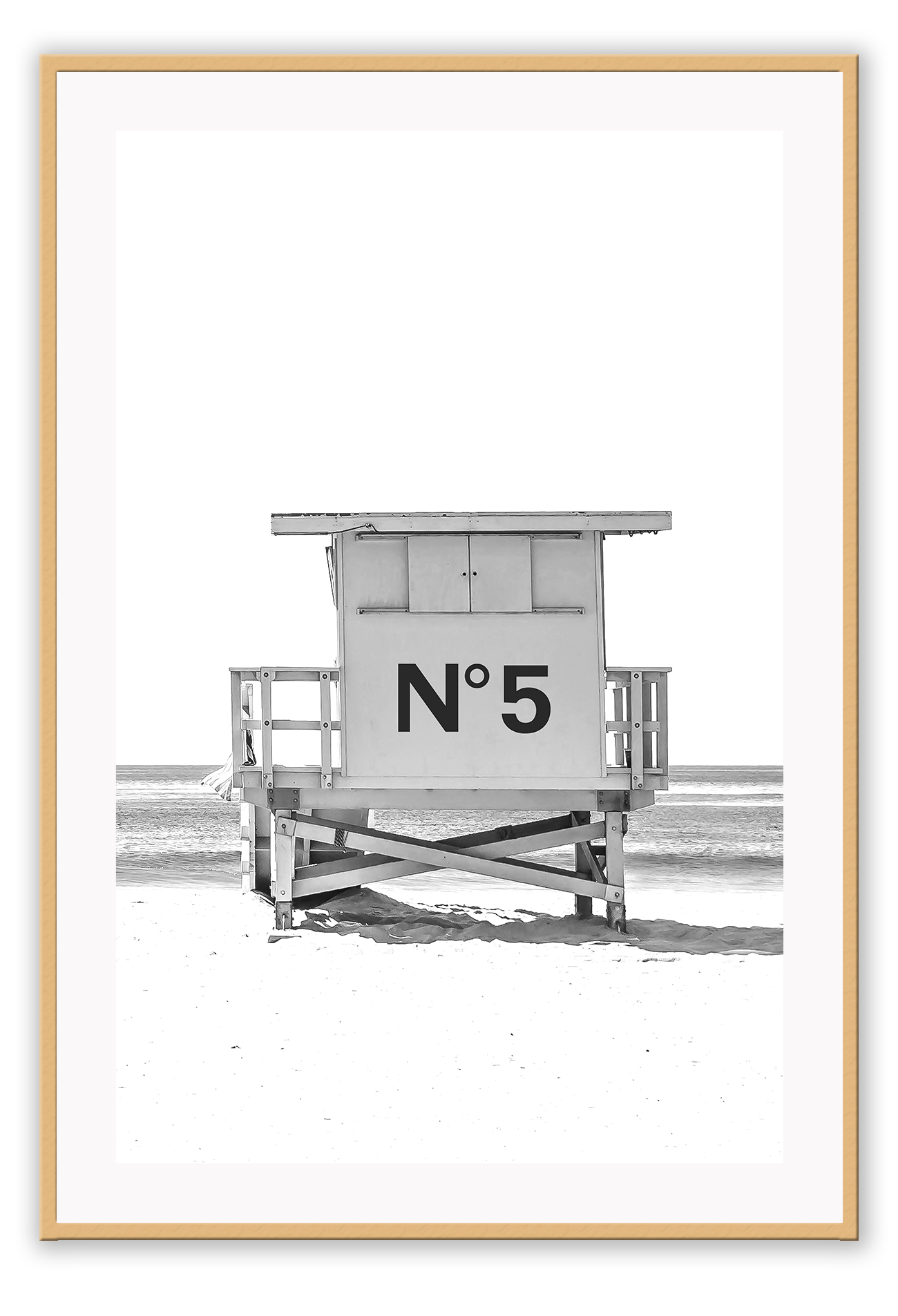 A black and white fashion wall art with black Chanel N5 fashion label on a beach cabin minimal