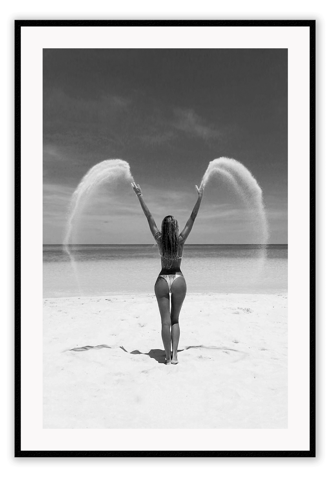 Sexy lady woman throwing sand on a beach in black and white, coastal ocean. 