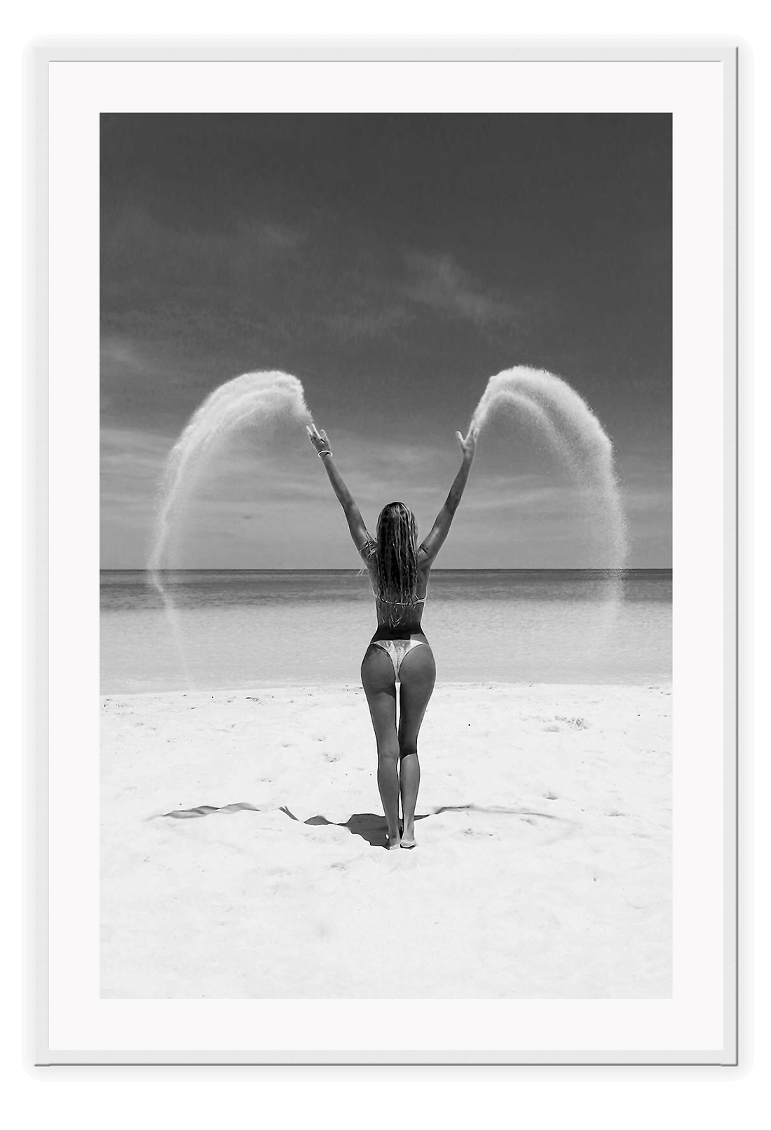 Sexy lady woman throwing sand on a beach in black and white, coastal ocean. 