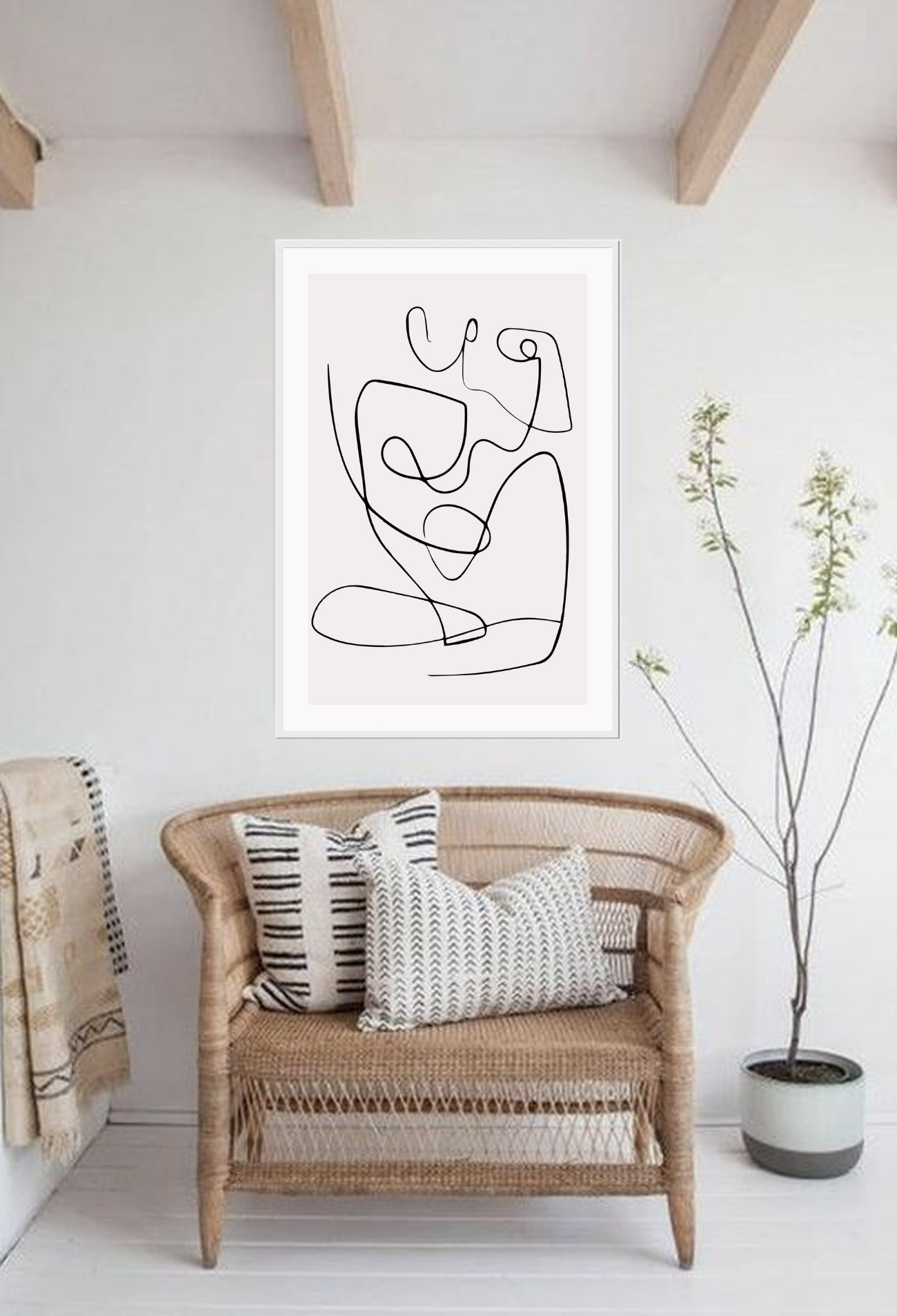 Line art print with black line creating female silhouette on a light pink background 