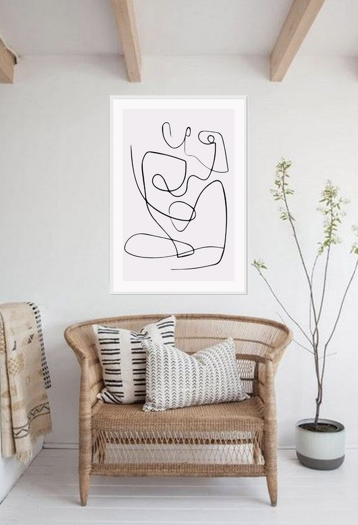 Line art print with black line creating female silhouette on a light pink background 