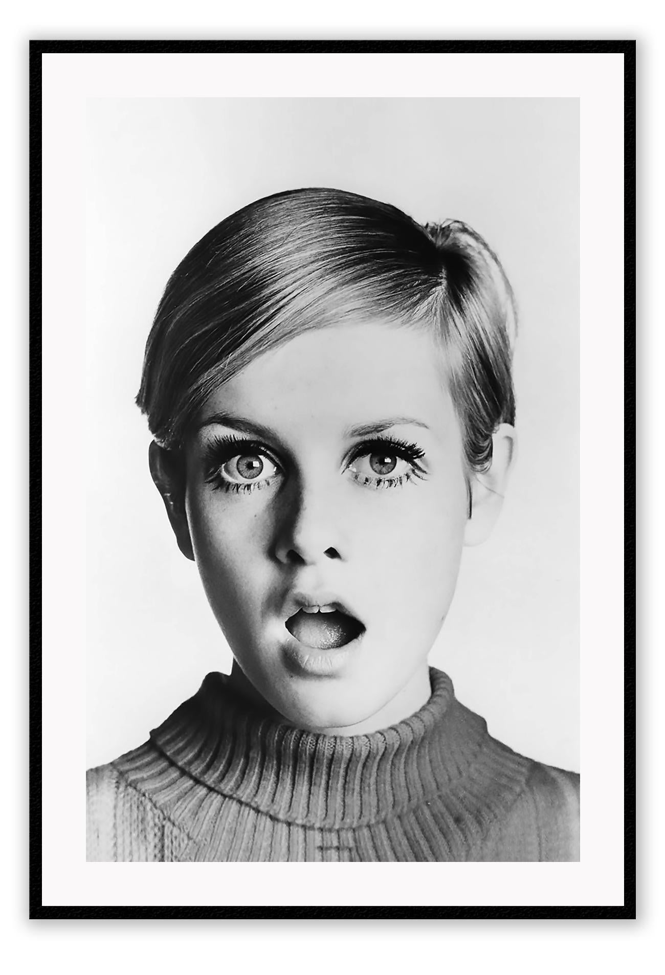 A framed black and white portrait of Twiggy looking directly at the camera with a surprised expression, mounted in a high quality custom made frame.
