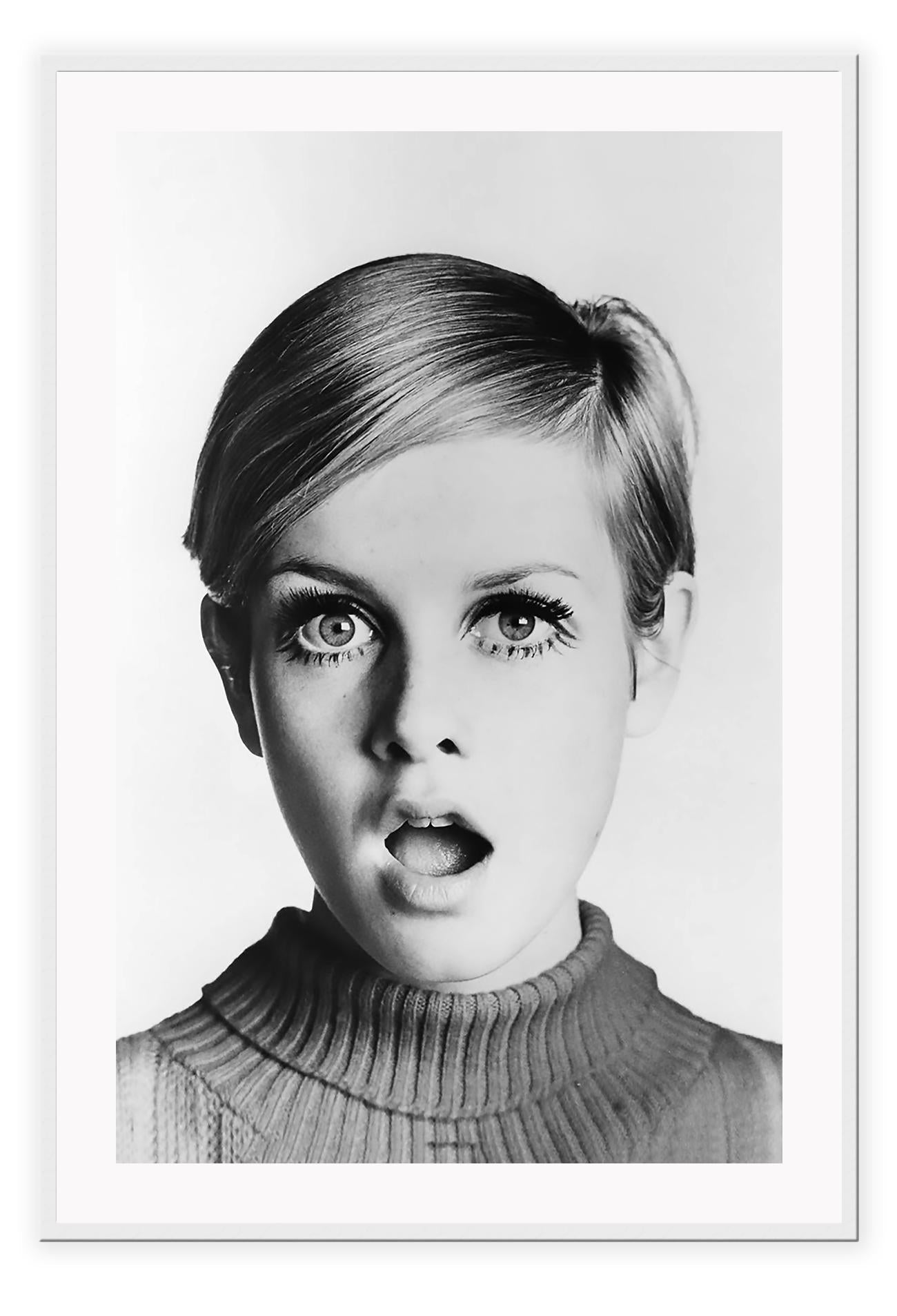 A framed black and white portrait of Twiggy looking directly at the camera with a surprised expression, mounted in a high quality custom made frame.