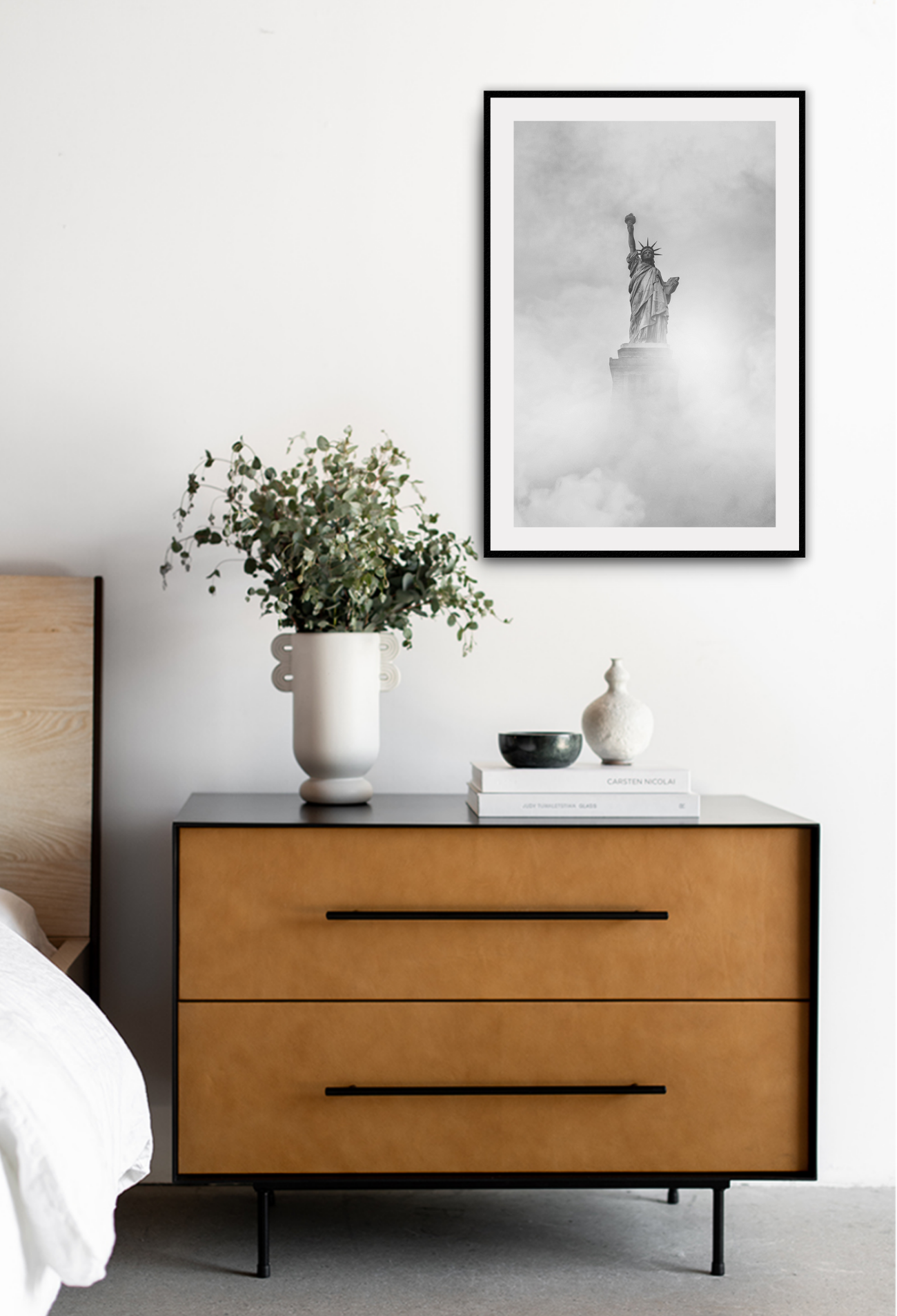 Statue of Liberty partially cover by fog, in black and white.