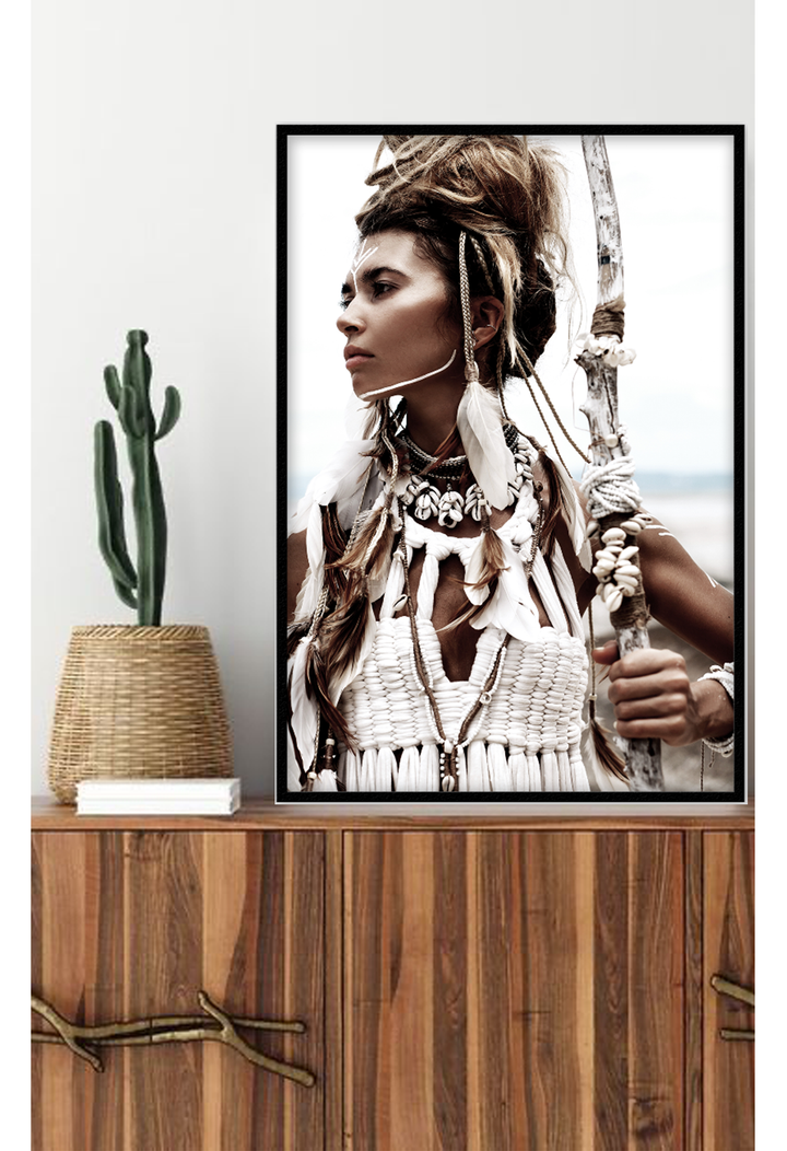 Tribal photography print with neutral colours boho scandi strong woman feather sticks ocean beach, set on white wall above timber cabinet
