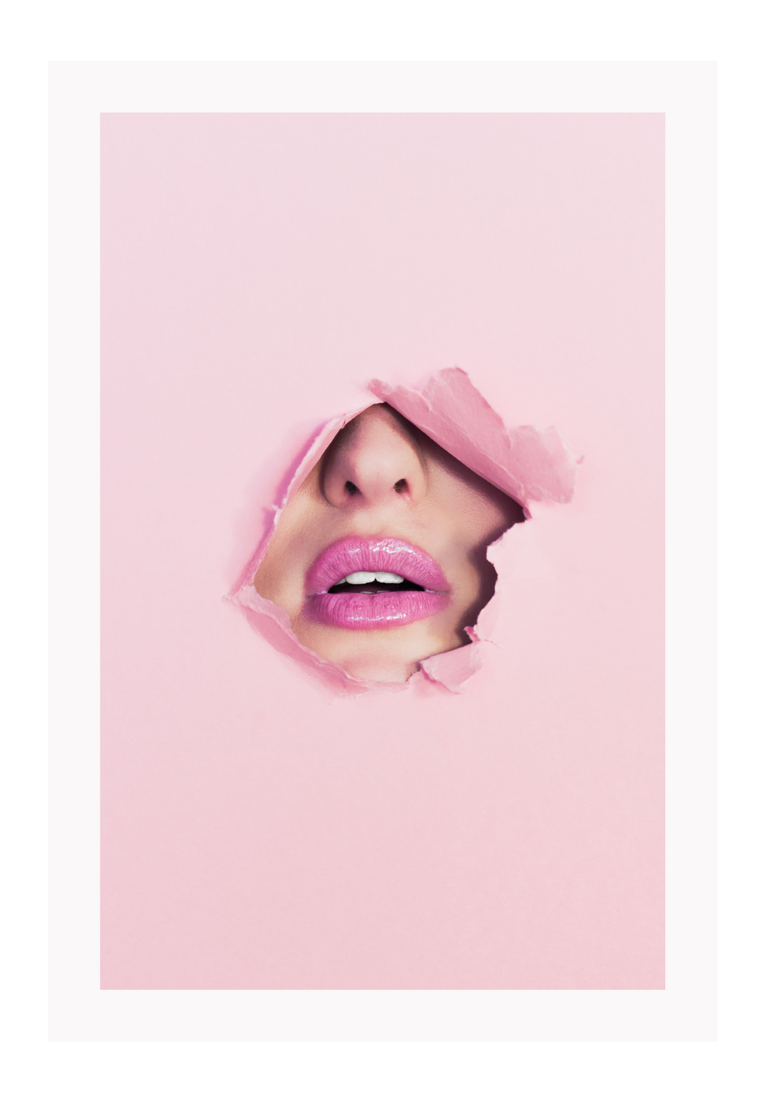 A pink wall art with fashion model face and pink lips. 