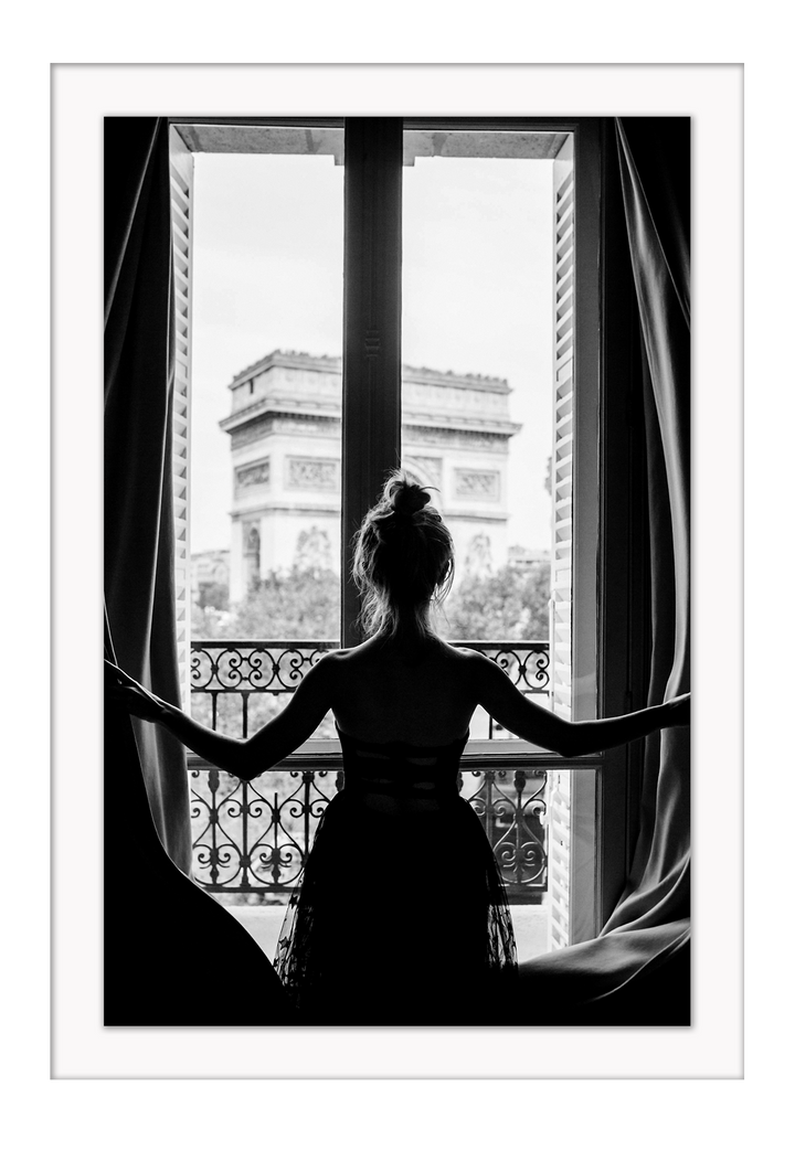 A black and white urban wall art with a girl looking out to the town from a vintage balcony in Paris. 