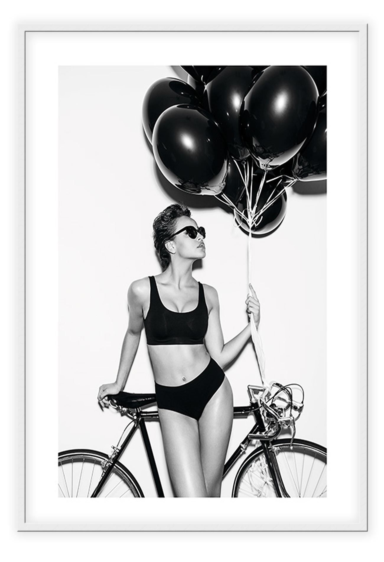 A fashion black and white wall art with a lady in lingerie holding balloons
