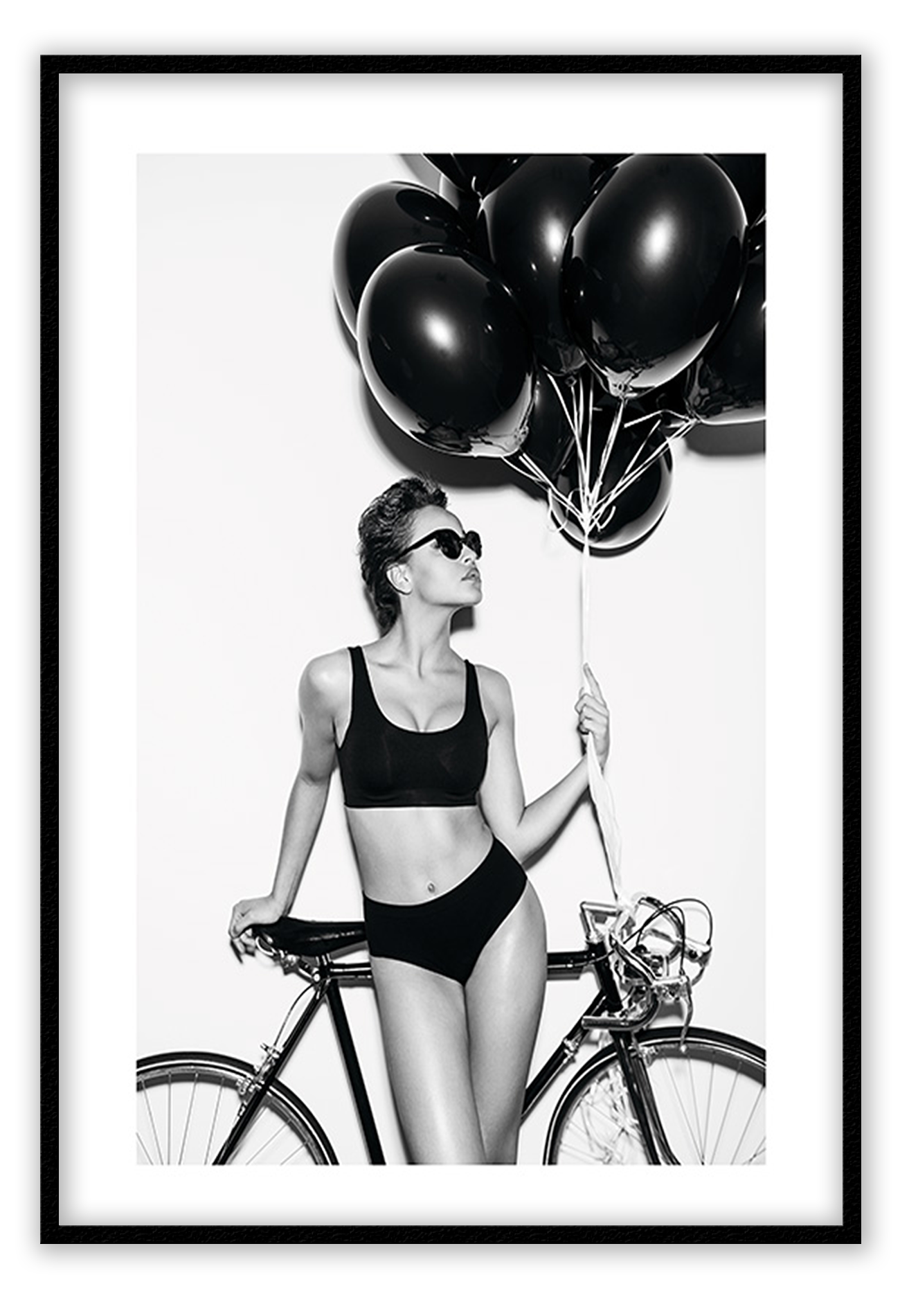 A fashion black and white wall art with a lady in lingerie holding balloons