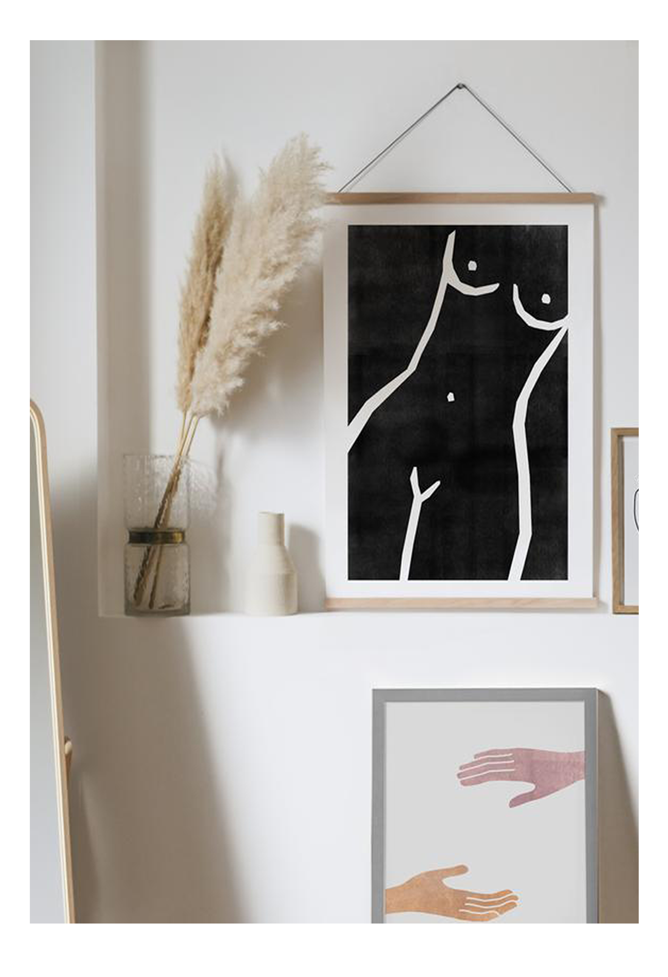 A black and white wall art with a nude woman sketch. 