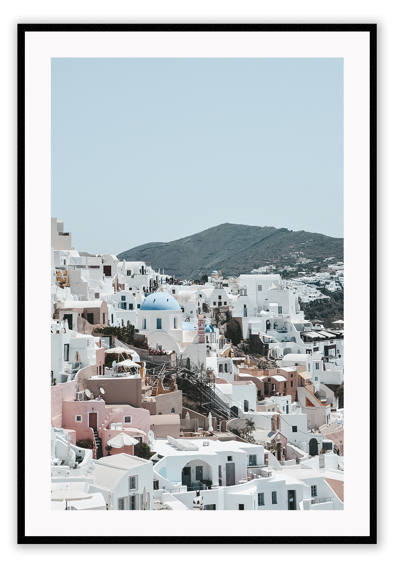 Greece, coastal architecture pastel colours blue sky mountain in background