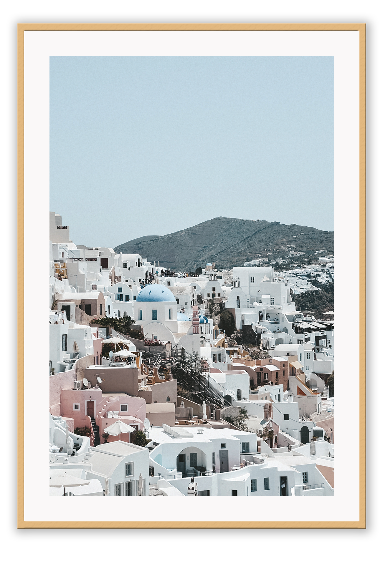 Greece, coastal architecture pastel colours blue sky mountain in background
