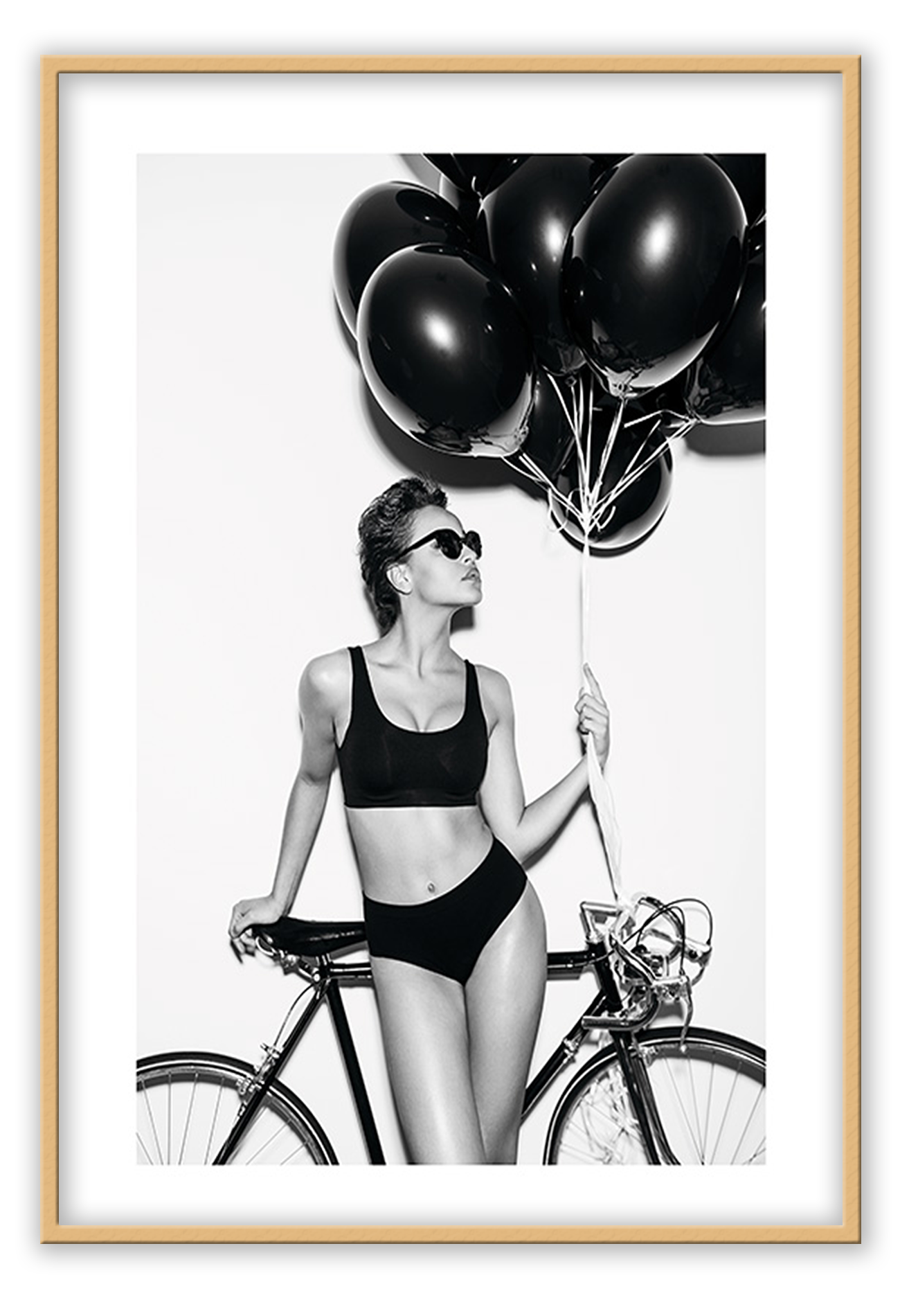 A fashion black and white wall art with a lady in lingerie holding balloons