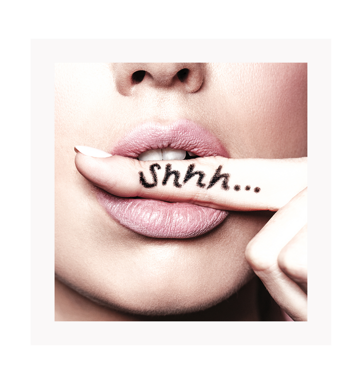 A fashion wall art with a sexy woman biting her finger saying shhh be quiet. 