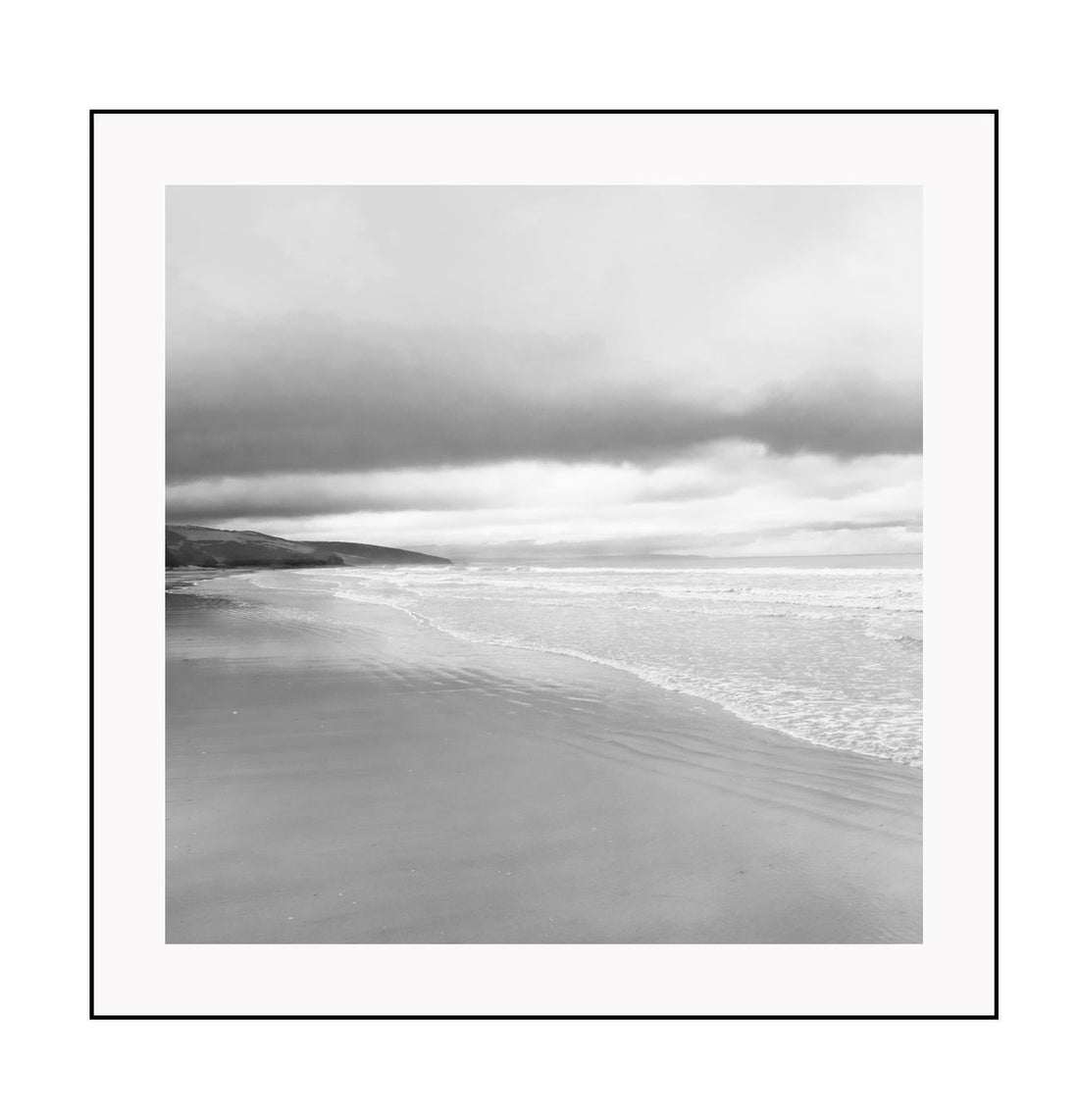 Black and white photograph of a beach scene with framed print boundaries.